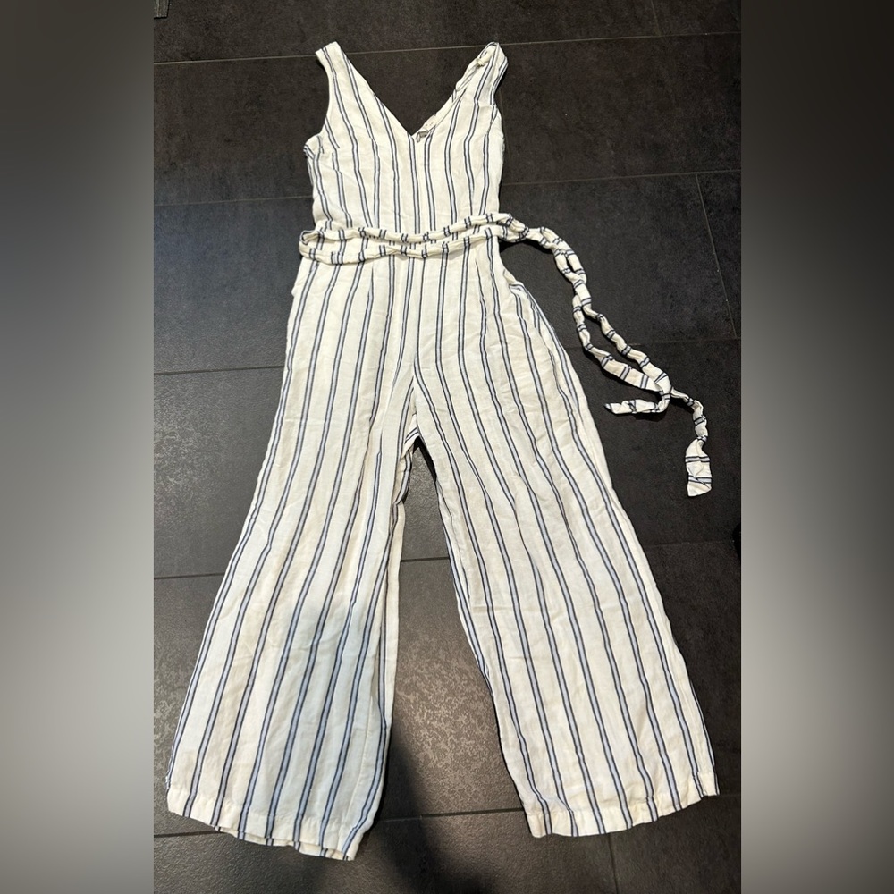 Size XS jump suit with draw string and pockets.